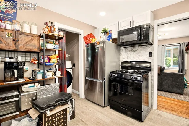 a kitchen with stainless steel appliances kitchen island a stove and a refrigerator