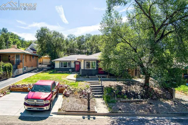 a view of a house with swimming pool and sitting area