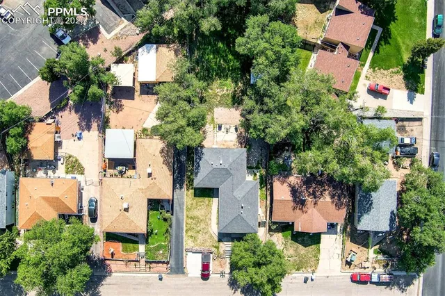 an aerial view of multiple houses with yard