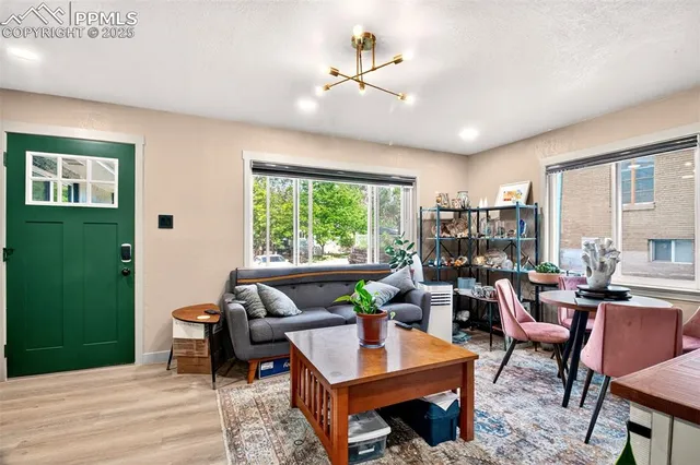 a living room with furniture a window and a chandelier