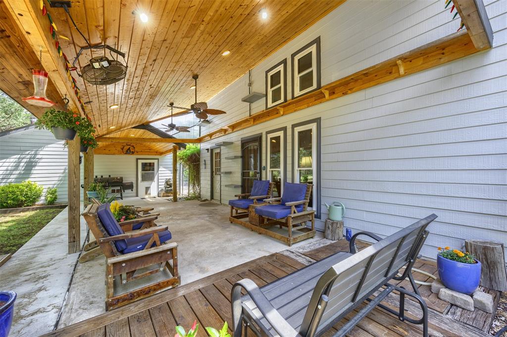 881 Wild Road Van Alstyne, TX 75495 - Photo 28 of 40 a view of a patio with table and chairs and floor to ceiling window next to a yard