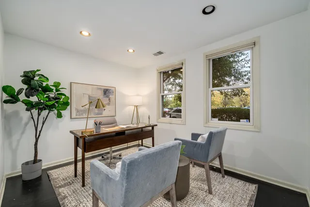 a living room with furniture and a potted plant