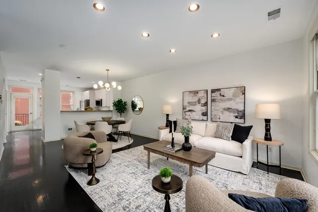 a living room with furniture kitchen view and a table