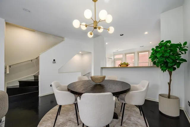 a view of a dining room with furniture and a potted plant