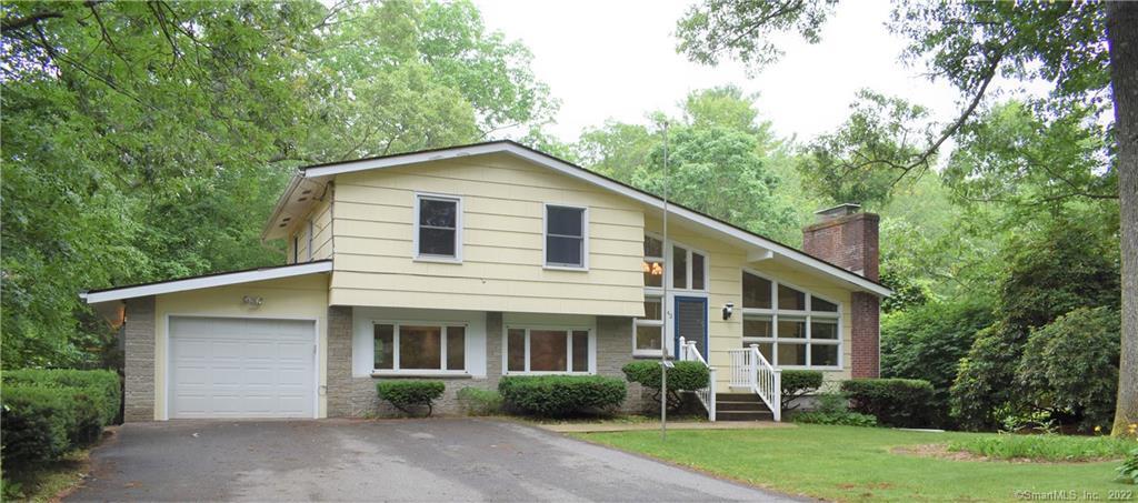42 Richard Road Ledyard, CT 06335 - Photo 1 of 1 a view of a yard in front of a house with plants and large trees
