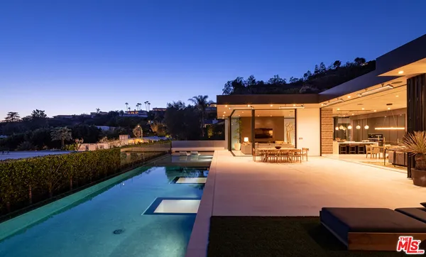 a view of a patio with swimming pool table and chairs