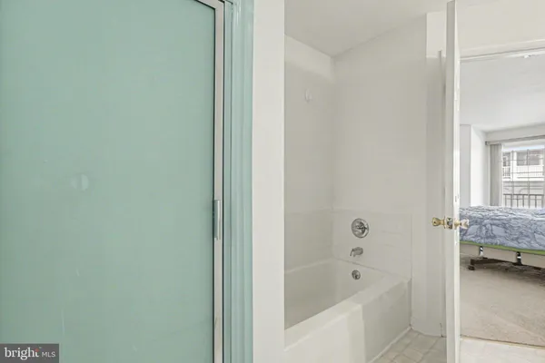 a bathroom with a tub and a shower