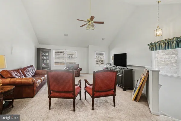 a view of a livingroom with furniture and a flat screen tv