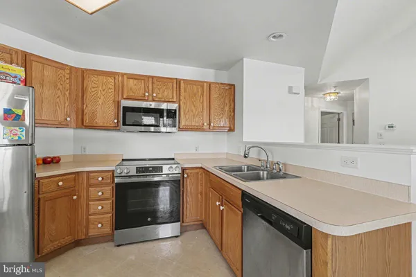a kitchen with a sink stove and cabinets