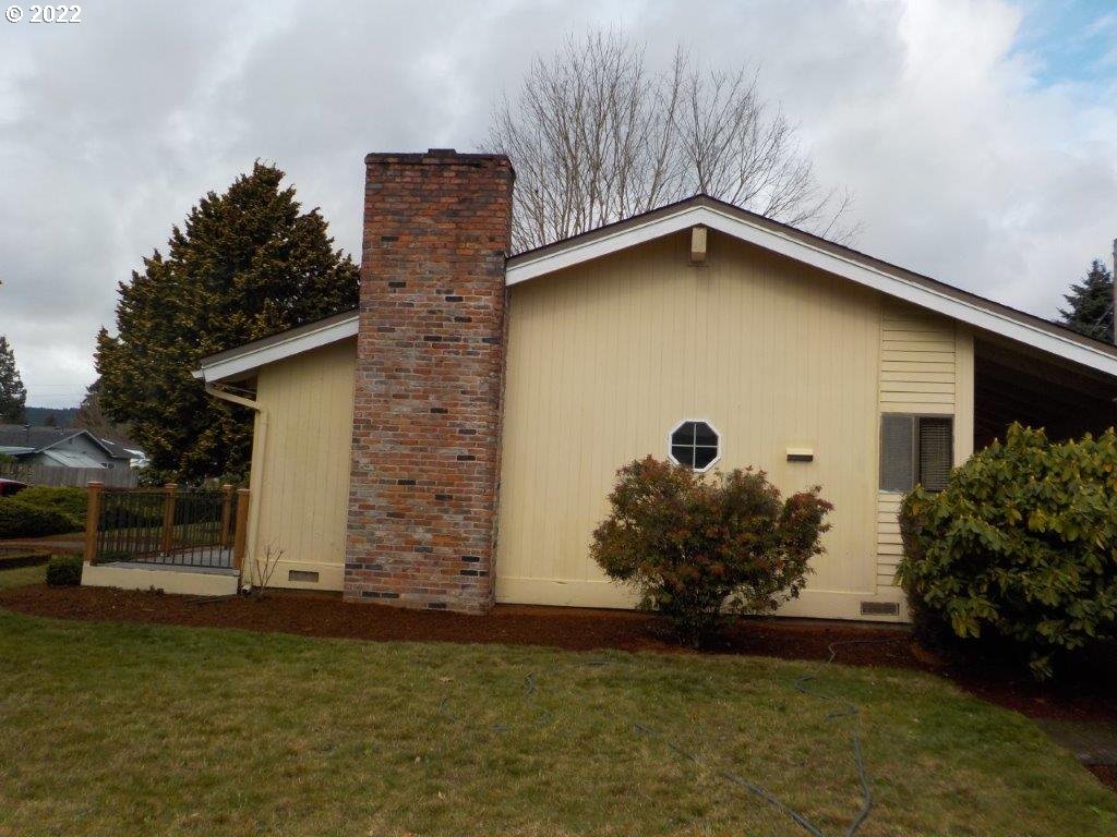 2215 20th Street Springfield, OR 97477 - Photo 6 of 27 a front view of a house with garden