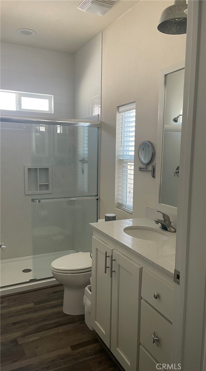 500 Atascadero Road Morro Bay, CA 93442 - Photo 25 of 45 a bathroom with a granite countertop toilet a sink and a mirror