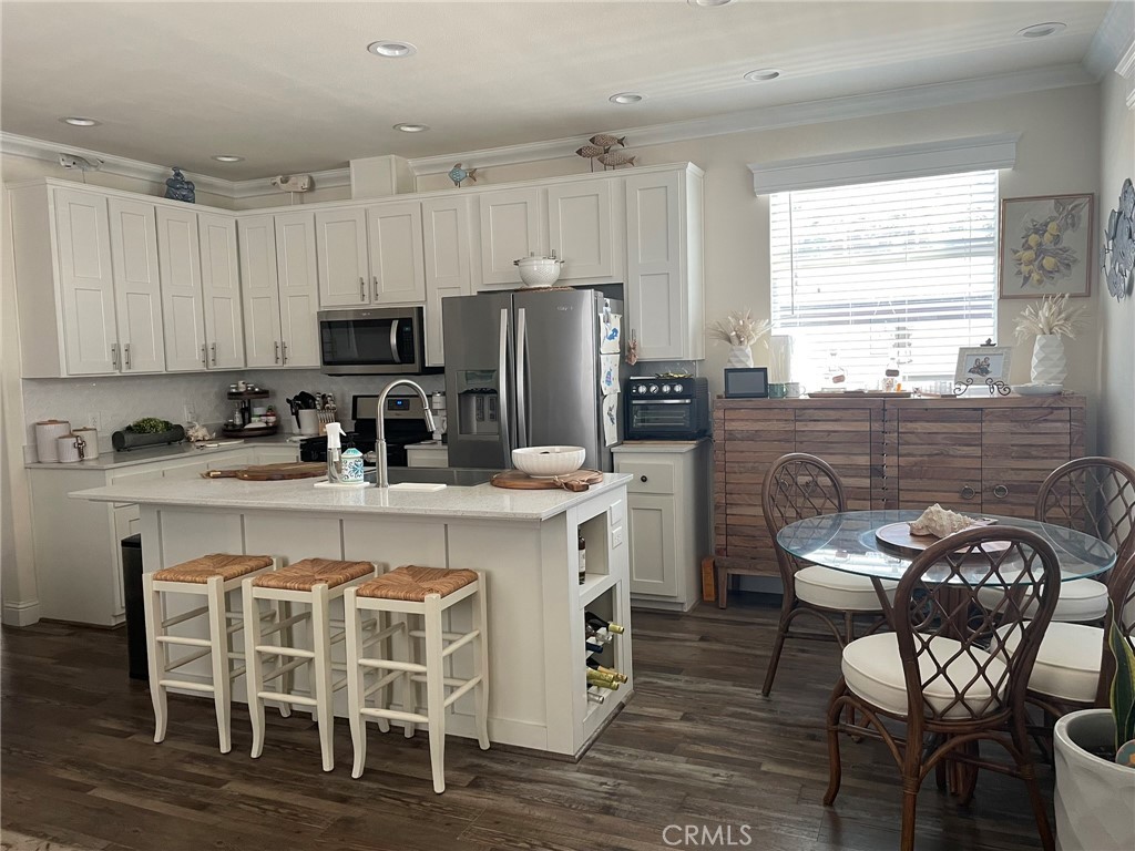 500 Atascadero Road Morro Bay, CA 93442 - Photo 10 of 45 a kitchen with stainless steel appliances granite countertop a table chairs sink refrigerator and cabinets