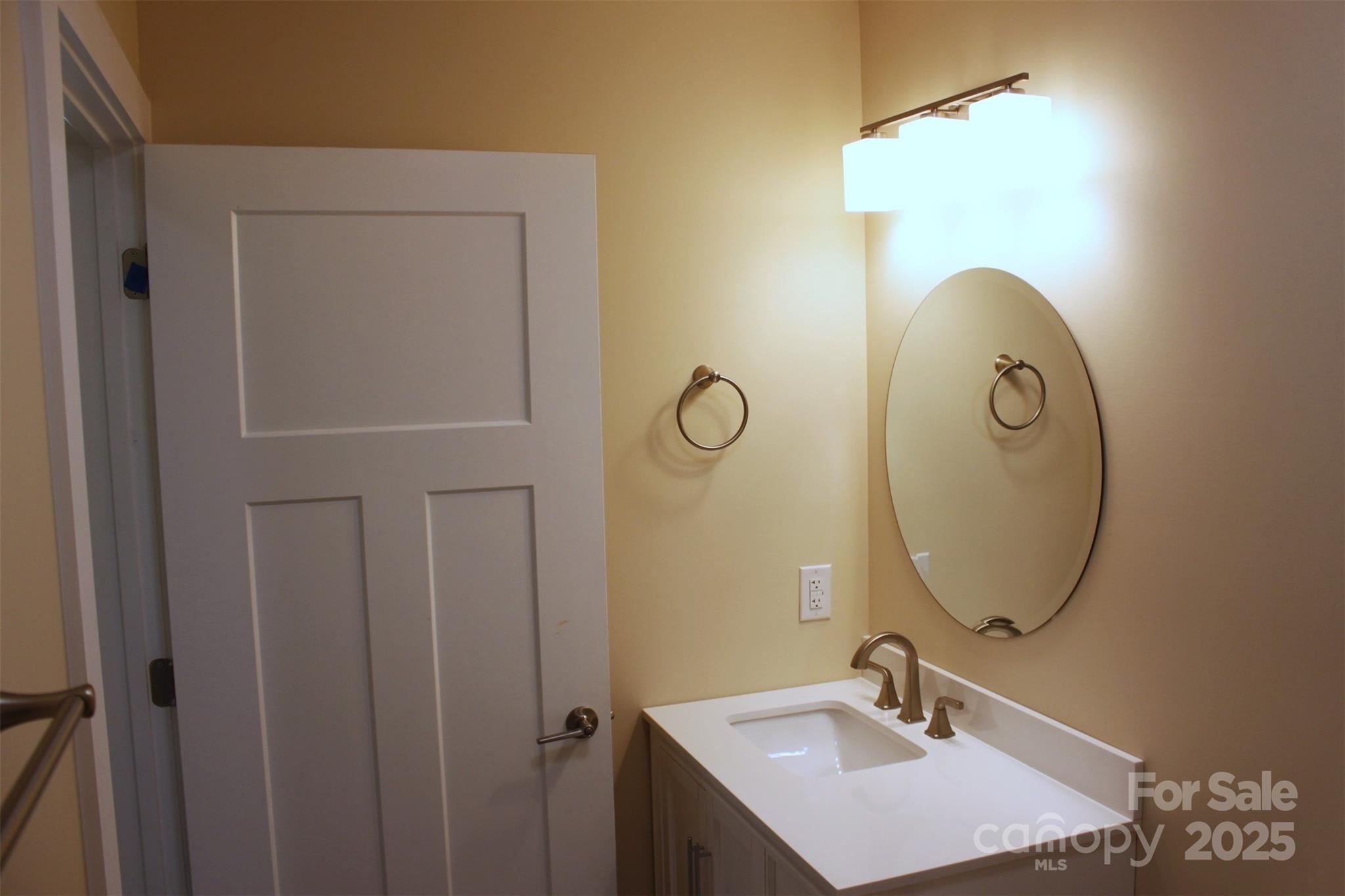 109 Blue Ridge Avenue Extension Elkin, NC 28621 - Photo 13 of 20 a bathroom with a sink and mirror