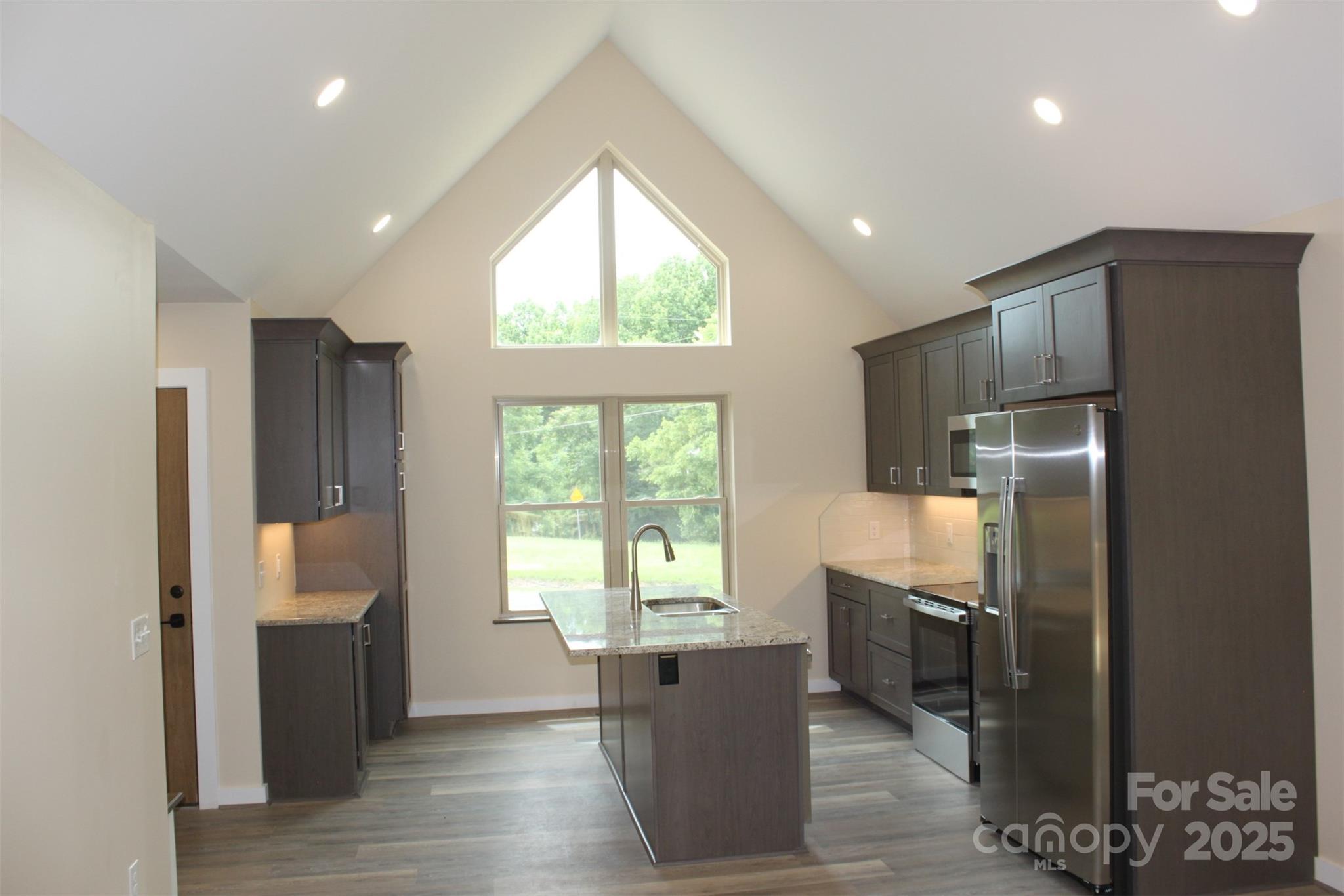 109 Blue Ridge Avenue Extension Elkin, NC 28621 - Photo 4 of 20 a kitchen with stainless steel appliances granite countertop a refrigerator and a sink