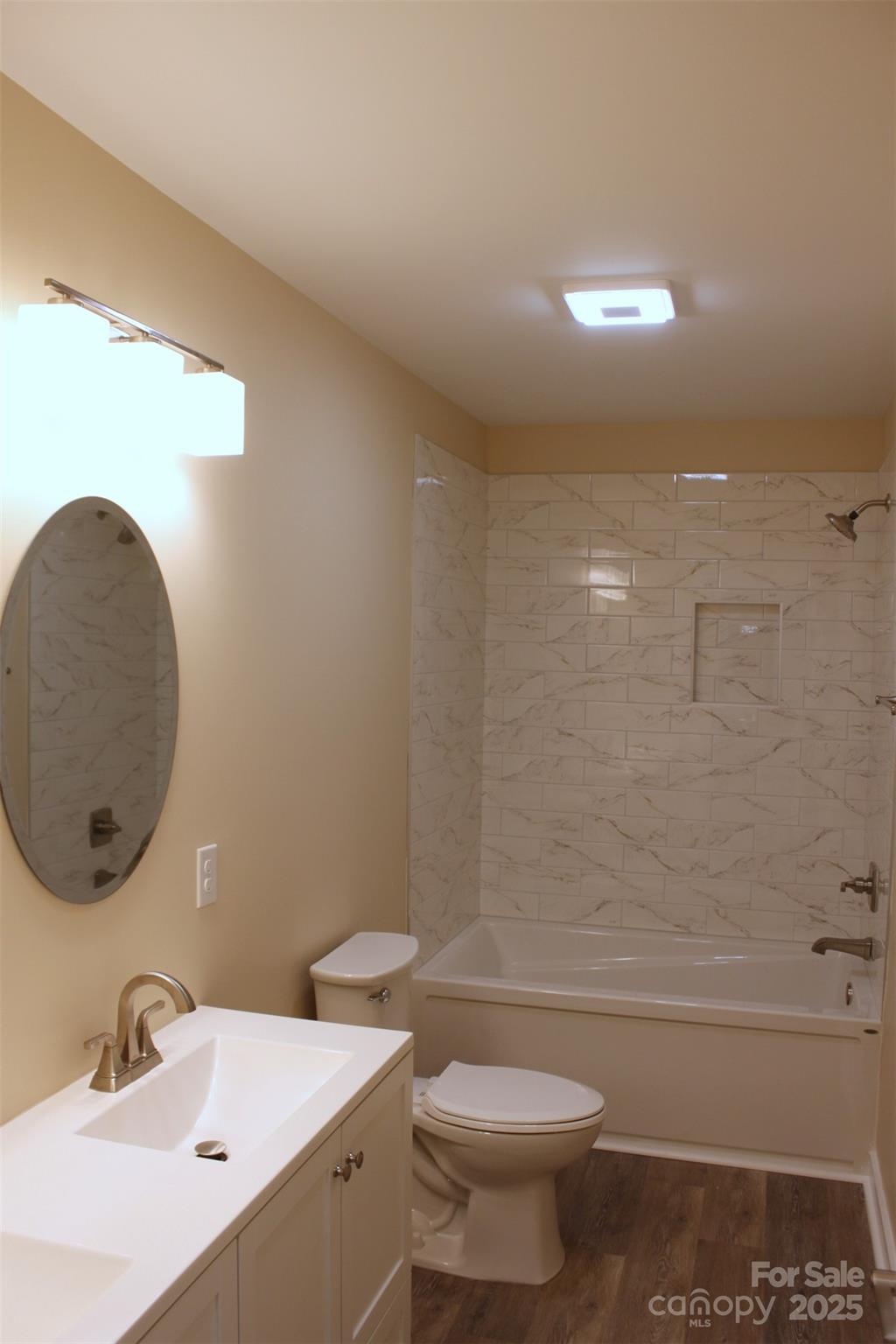 109 Blue Ridge Avenue Extension Elkin, NC 28621 - Photo 10 of 20 a bathroom with a sink a toilet and a mirror