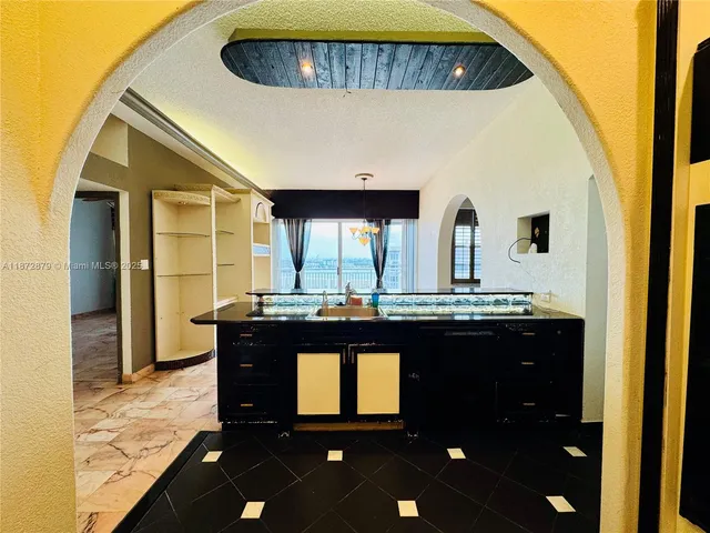 a kitchen with a sink and cabinets