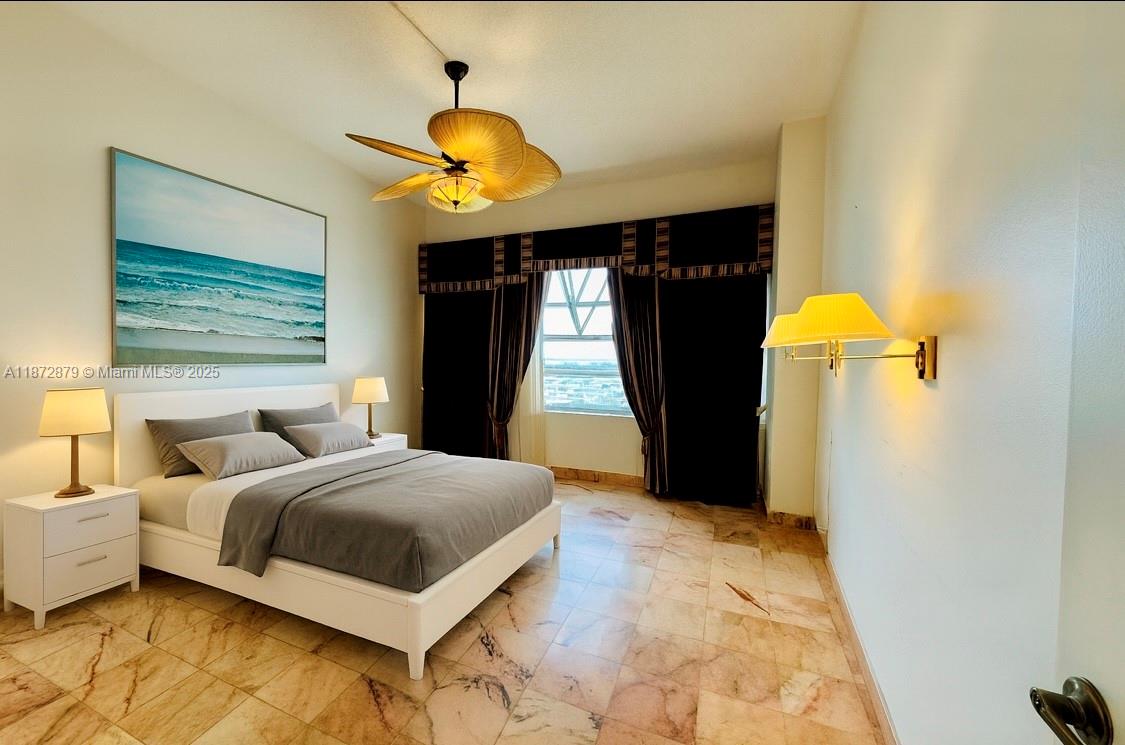 18071 Biscayne Boulevard, Unit PH04 & PH03 Aventura, FL 33160 - Photo 7 of 26 a bedroom with a bed and a chandelier