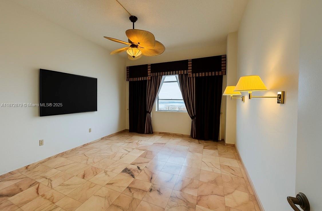 18071 Biscayne Boulevard, Unit PH04 & PH03 Aventura, FL 33160 - Photo 10 of 26 a view of a livingroom with a flat screen tv and fan