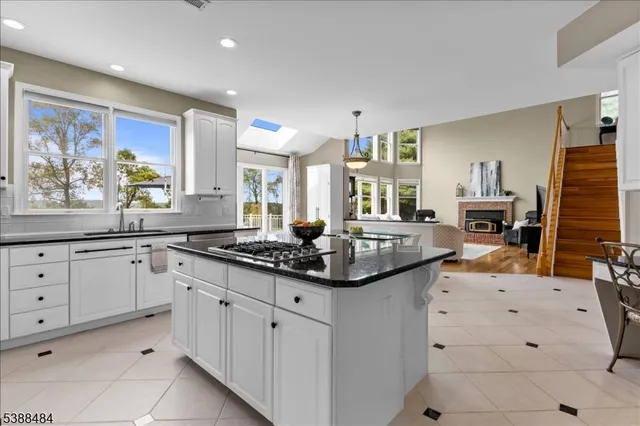 a kitchen with granite countertop a sink and cabinets