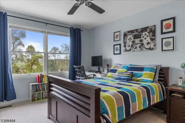 a bedroom with a bed and a large window