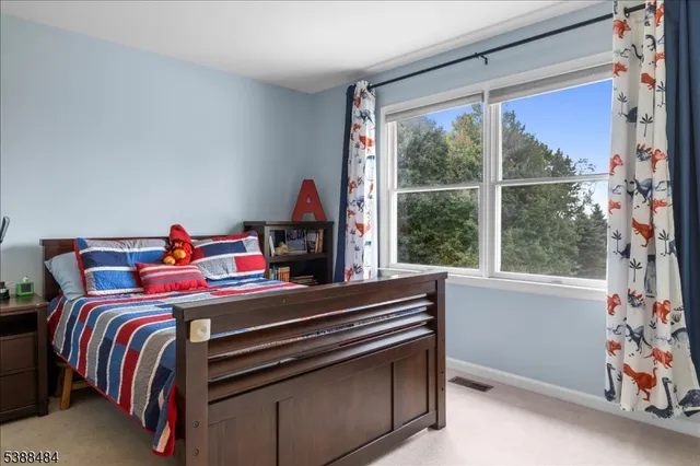 a bed sitting in a bedroom next to a window