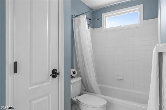 a bathroom with a shower a toilet and a sink