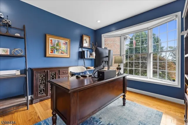 a work room with furniture and a large window