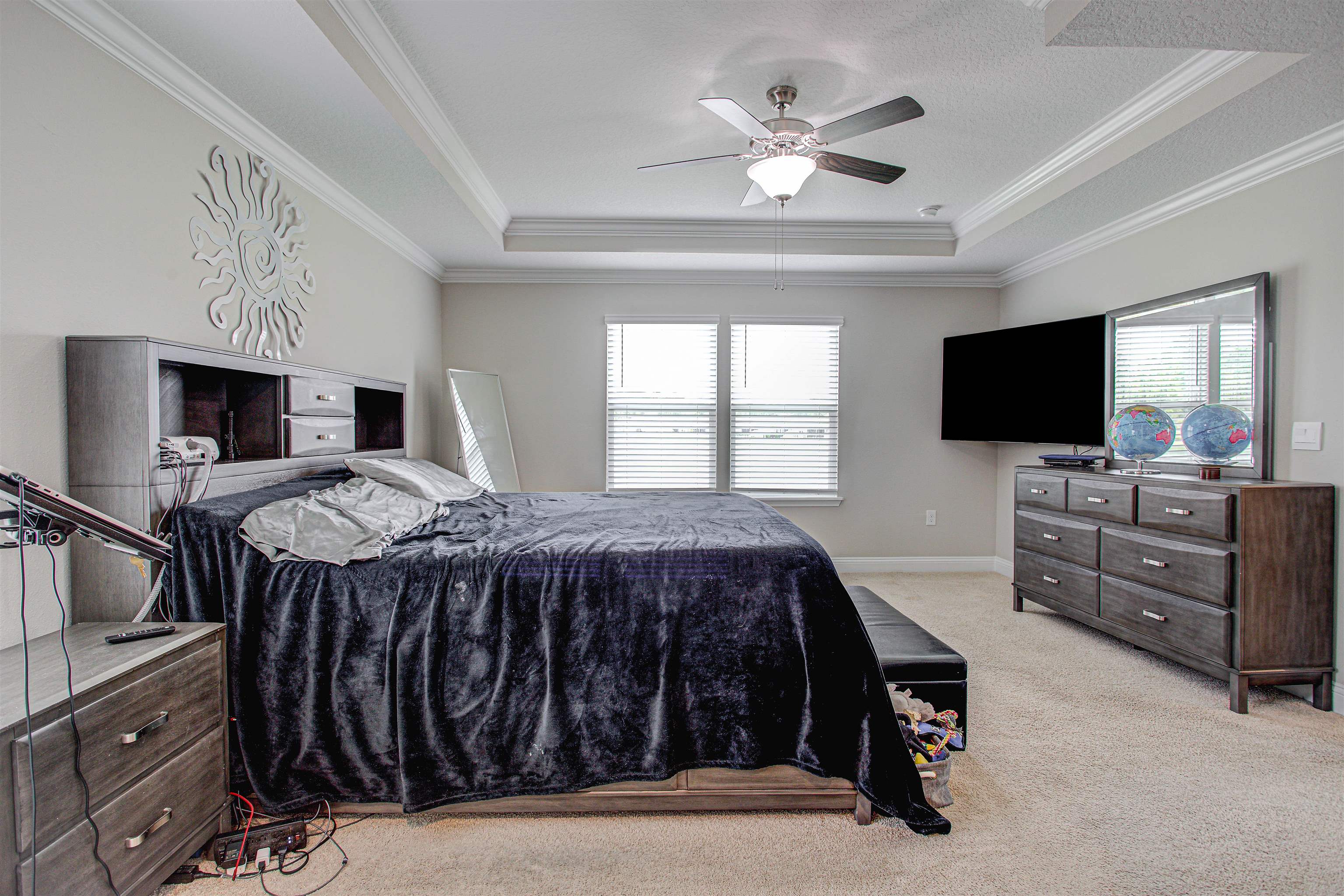 721 Narvarez Avenue St. Augustine, FL 32084 - Photo 19 of 59 Bedroom featuring light colored carpet, multiple windows, ceiling fan, a raised ceiling, and ornamental molding