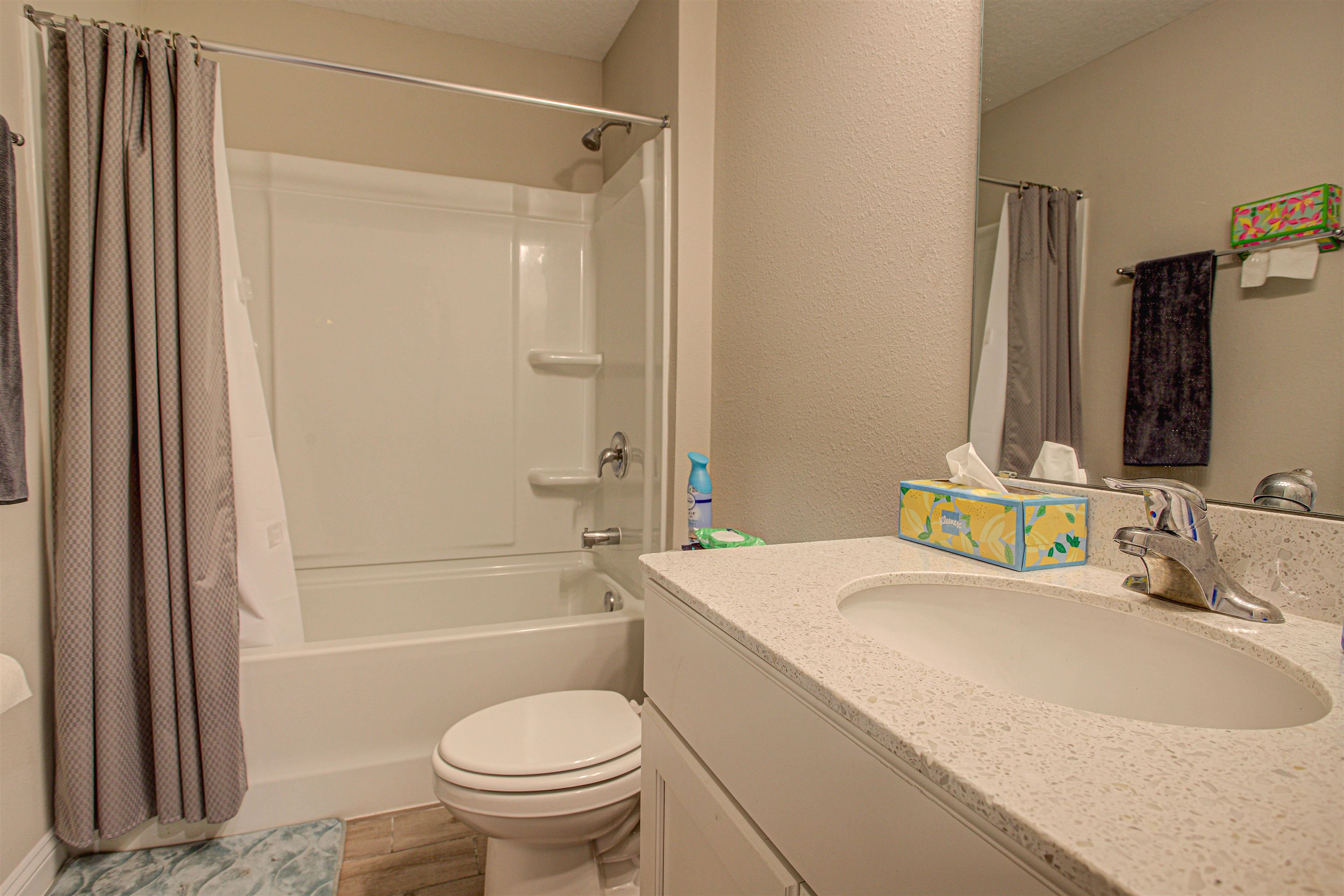 721 Narvarez Avenue St. Augustine, FL 32084 - Photo 27 of 59 Full bathroom with shower / bath combo with shower curtain, vanity, a textured wall, and light wood-style floors