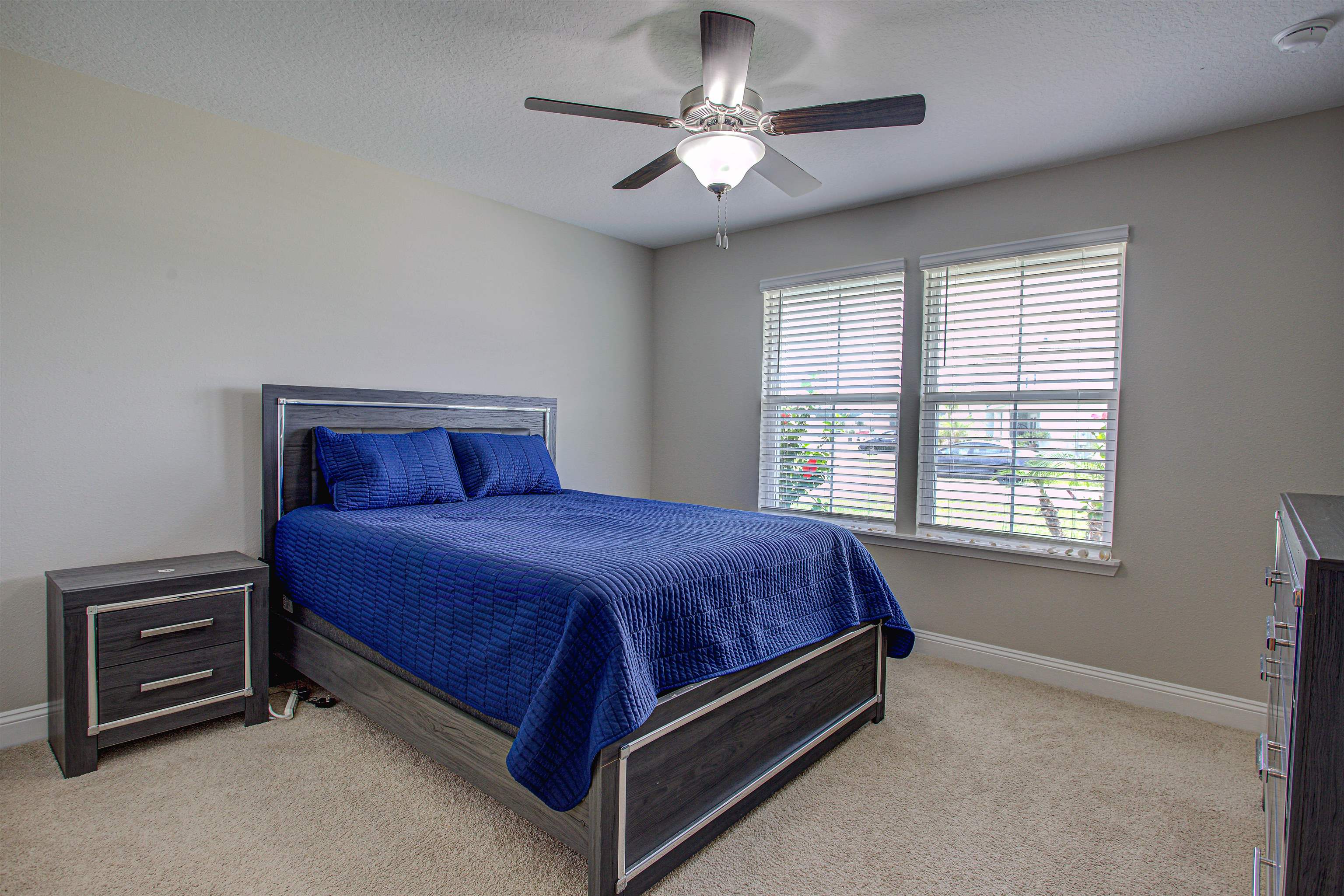 721 Narvarez Avenue St. Augustine, FL 32084 - Photo 29 of 59 Bedroom featuring light colored carpet, a textured ceiling, and a ceiling fan