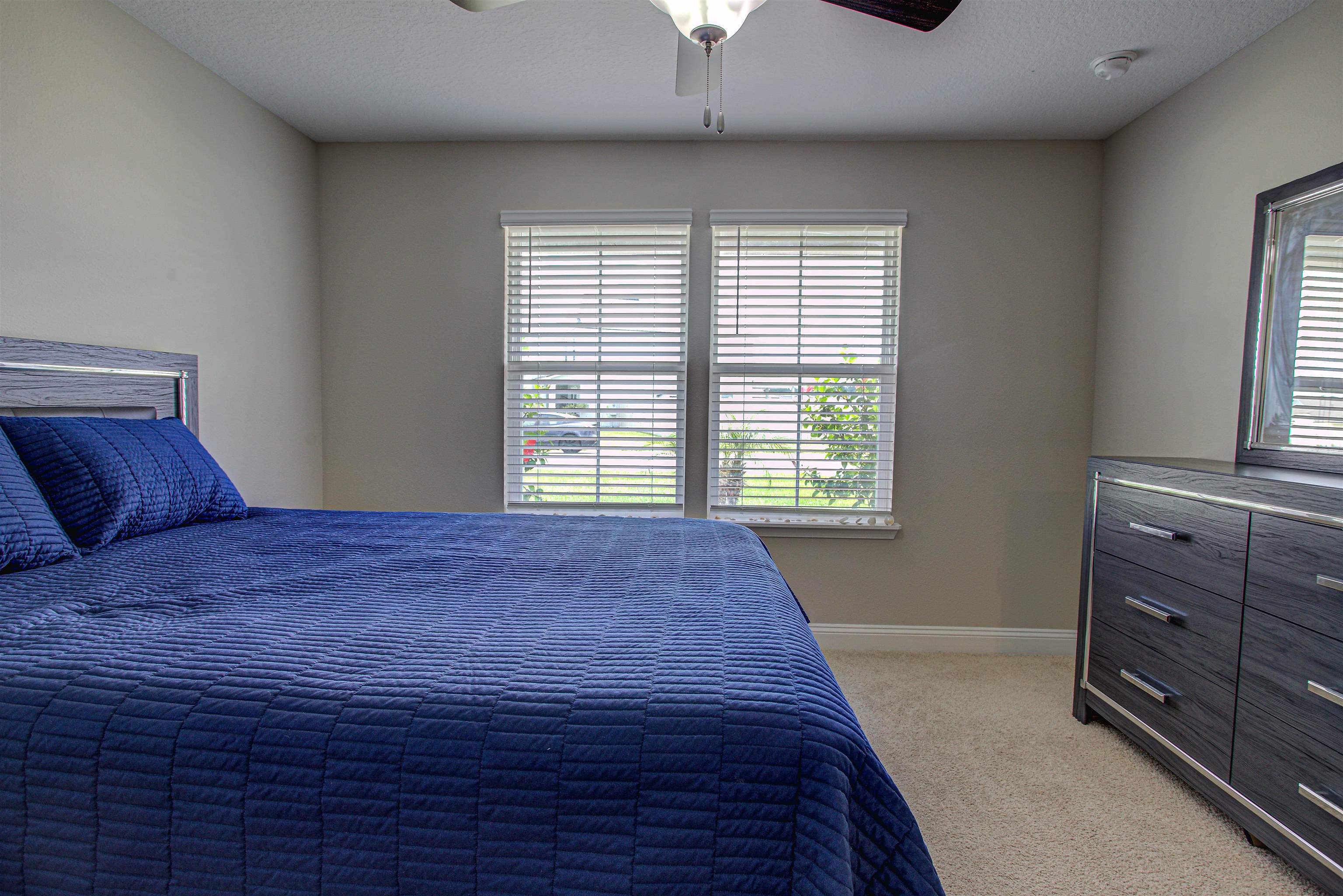 721 Narvarez Avenue St. Augustine, FL 32084 - Photo 30 of 59 Bedroom featuring light colored carpet, ceiling fan, and a textured ceiling