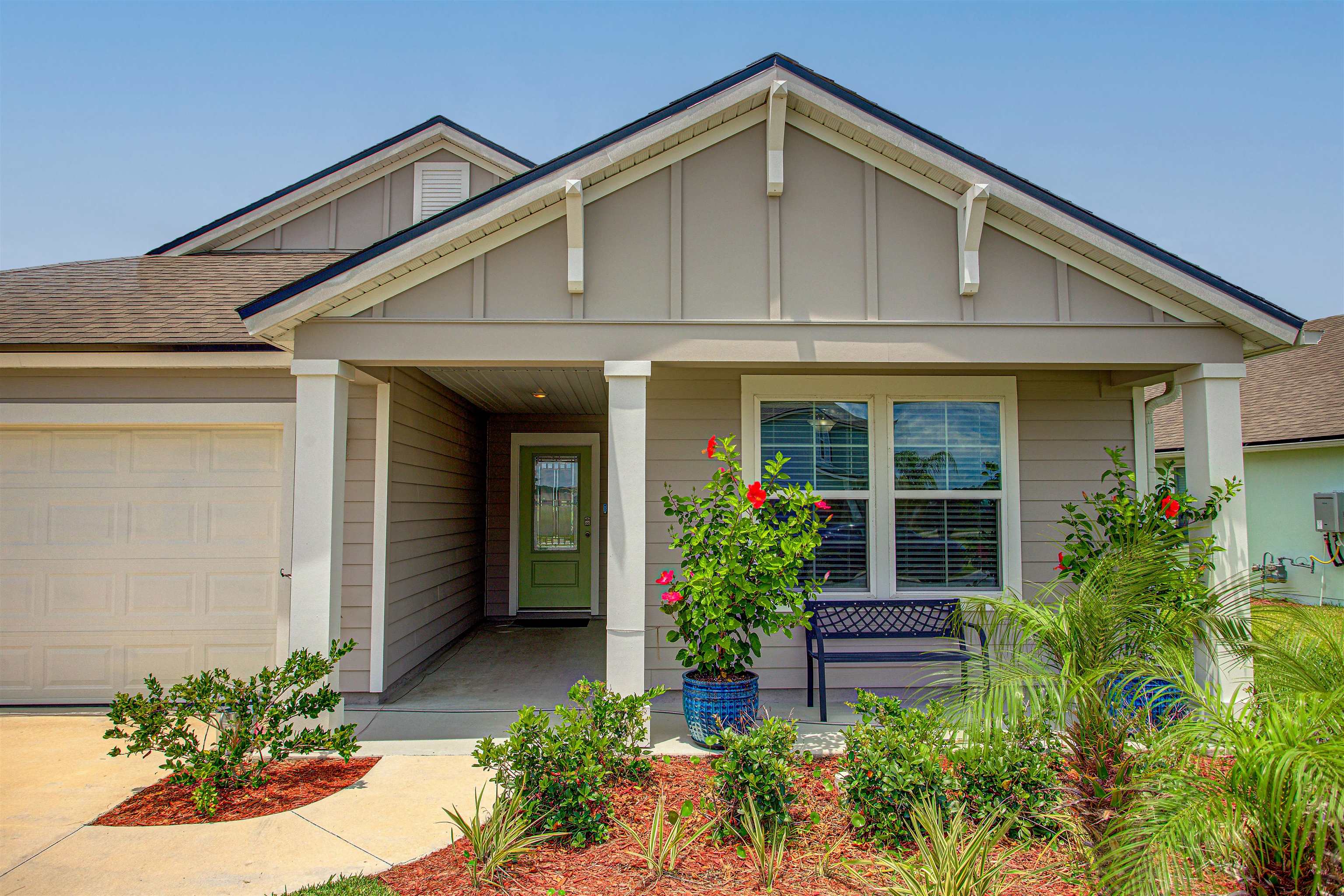 721 Narvarez Avenue St. Augustine, FL 32084 - Photo 5 of 59 View of front of property featuring board and batten siding, a porch, a garage, and a shingled roof