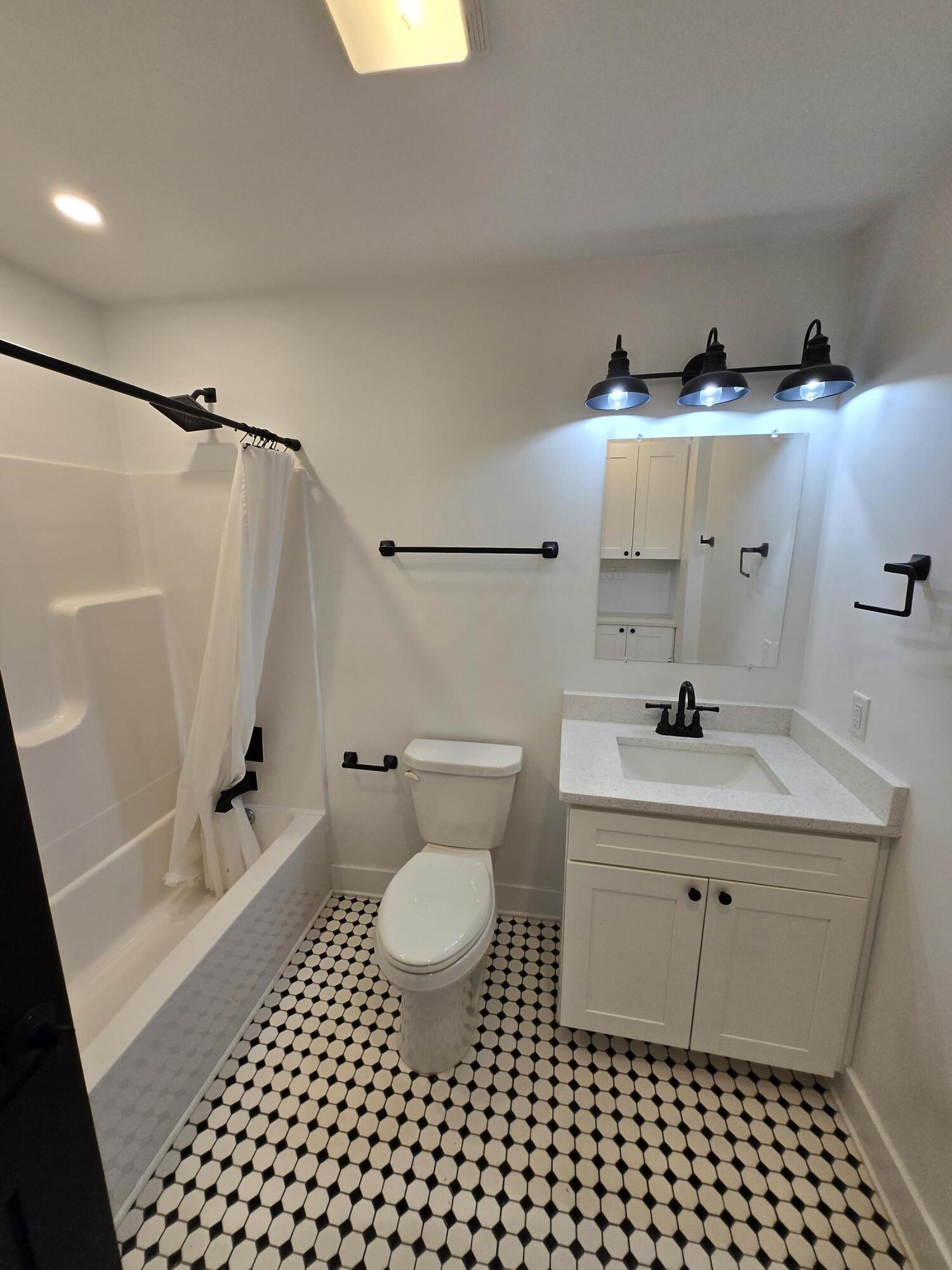 506 Locust Street Valparaiso, IN 46383 - Photo 17 of 34 a bathroom with a sink toilet a shower and a mirror