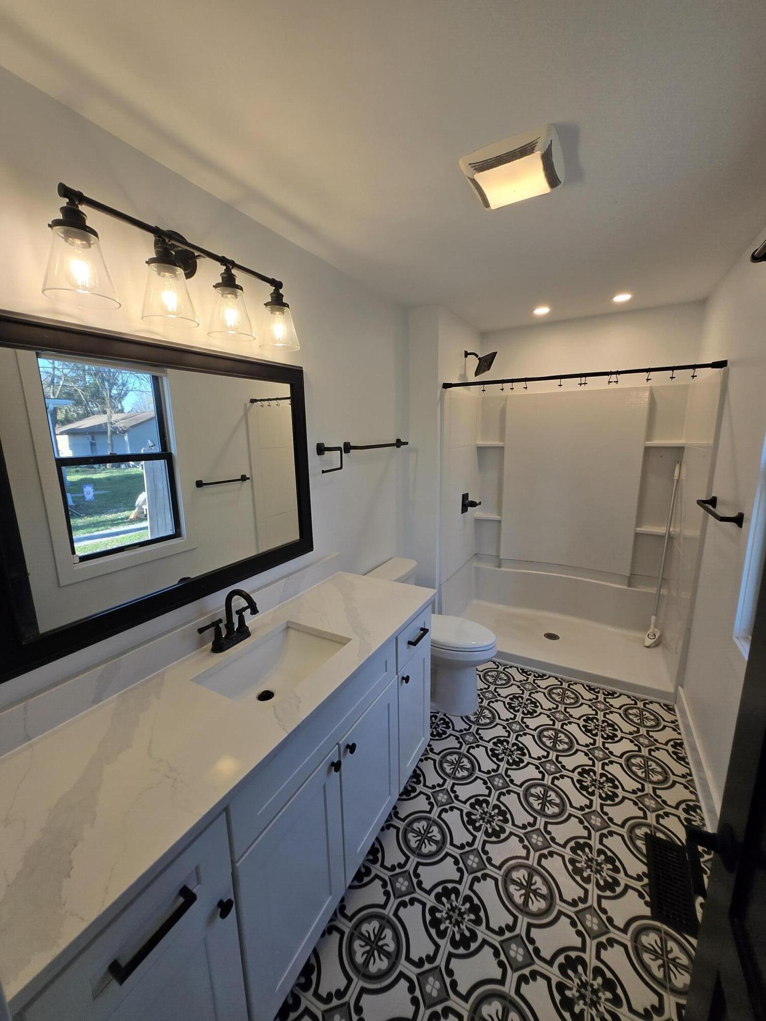 506 Locust Street Valparaiso, IN 46383 - Photo 21 of 34 a bathroom with a sink a toilet and mirror