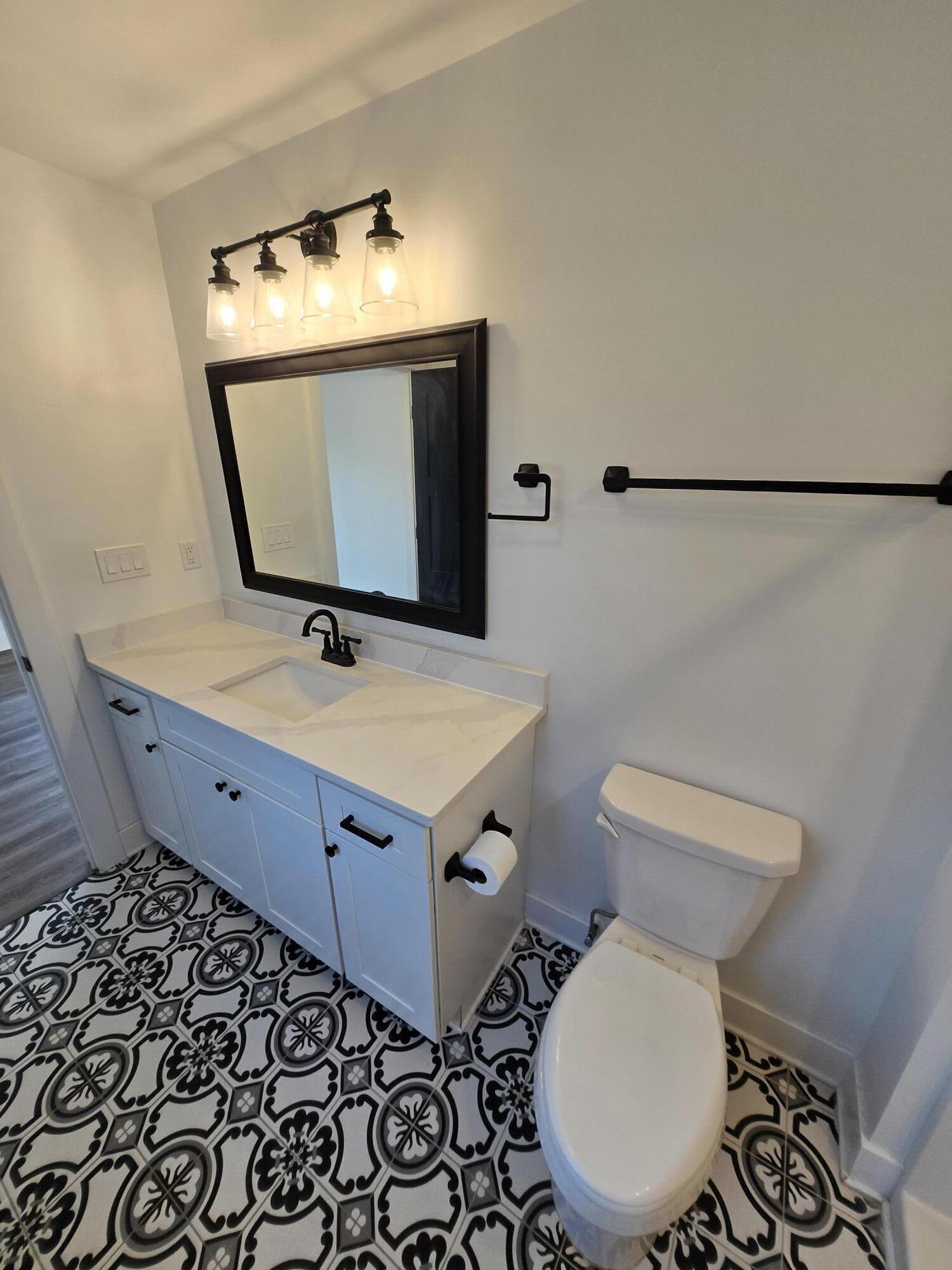 506 Locust Street Valparaiso, IN 46383 - Photo 22 of 34 a bathroom with a toilet sink and mirror
