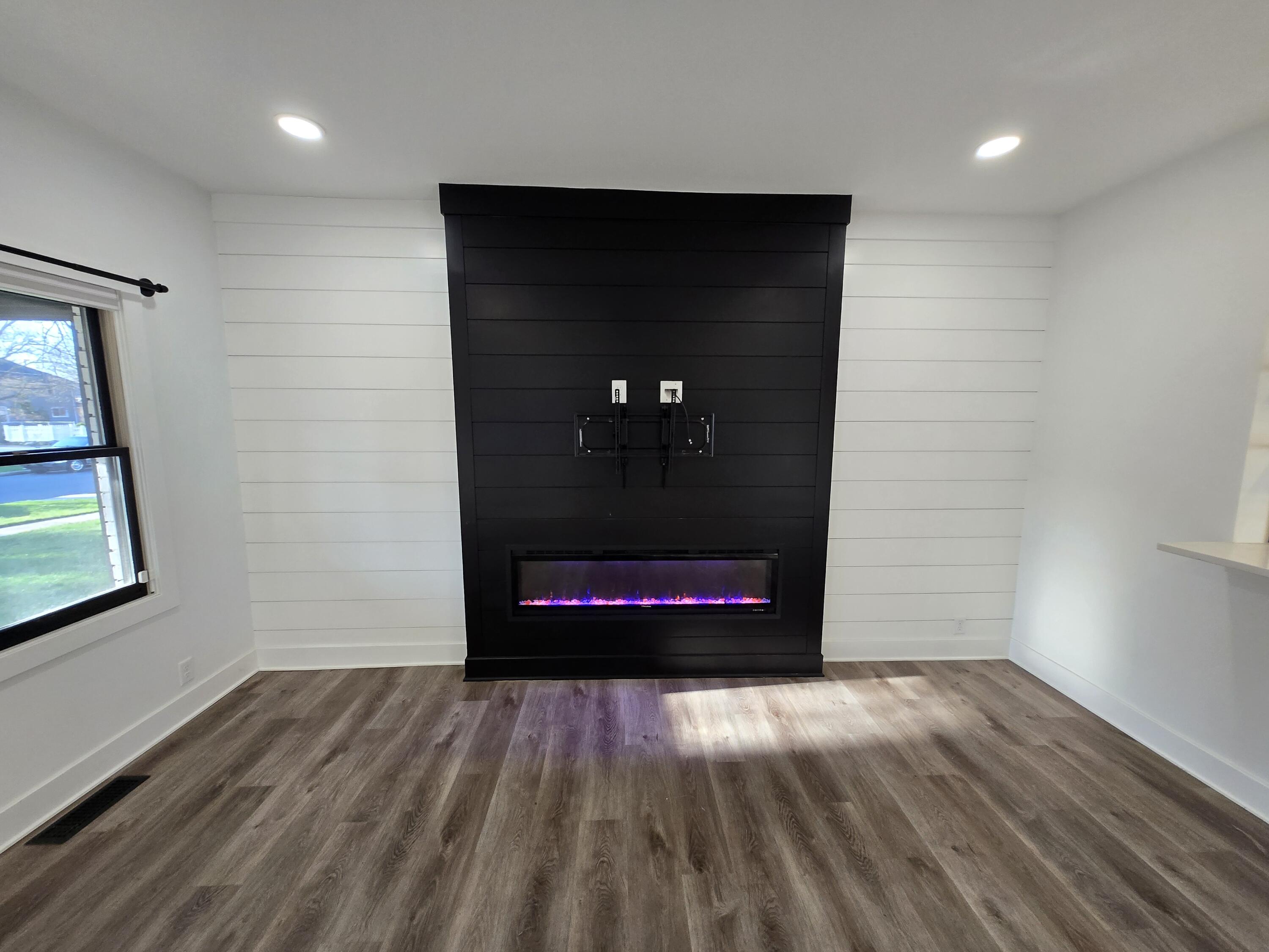 506 Locust Street Valparaiso, IN 46383 - Photo 5 of 34 an empty room with wooden floor and windows