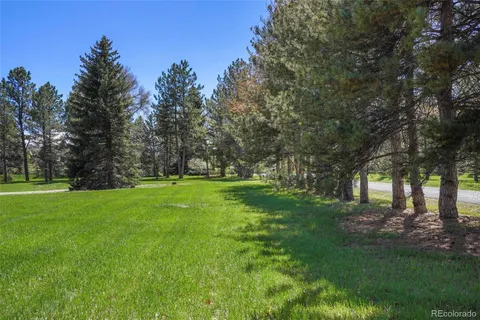 a view of a room with a yard and mountain view in back
