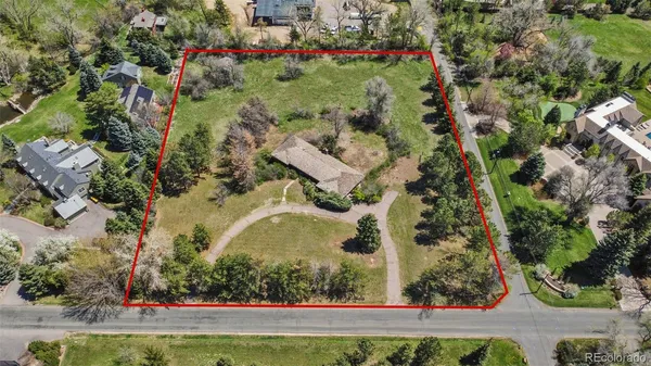 an aerial view of a residential houses with yard