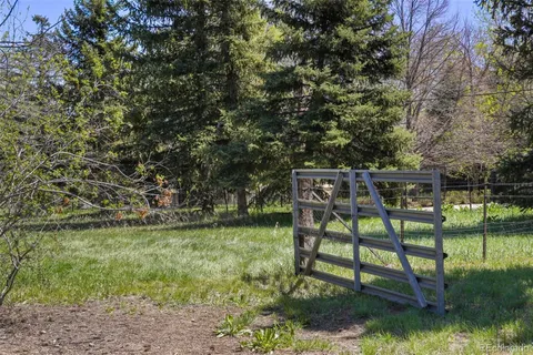 a view of a bench in the garden near a lake