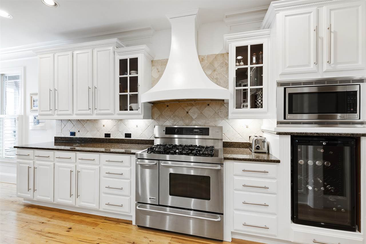1806 10th Avenue Raleigh, NC 27607 - Photo 6 of 30 Kitchen offers double dishwashers, stainless steel appliances, and plenty of counter space for home-cooked meals, plus views of the backyard green Graceful Lines
