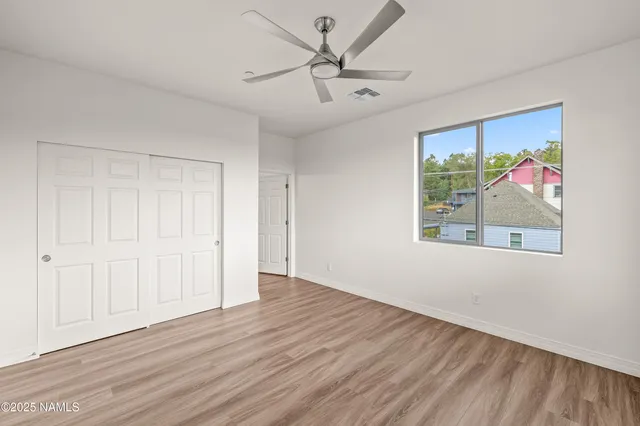 wooden floor in an empty room with a window