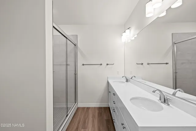 a bathroom with a sink a mirror and a shower