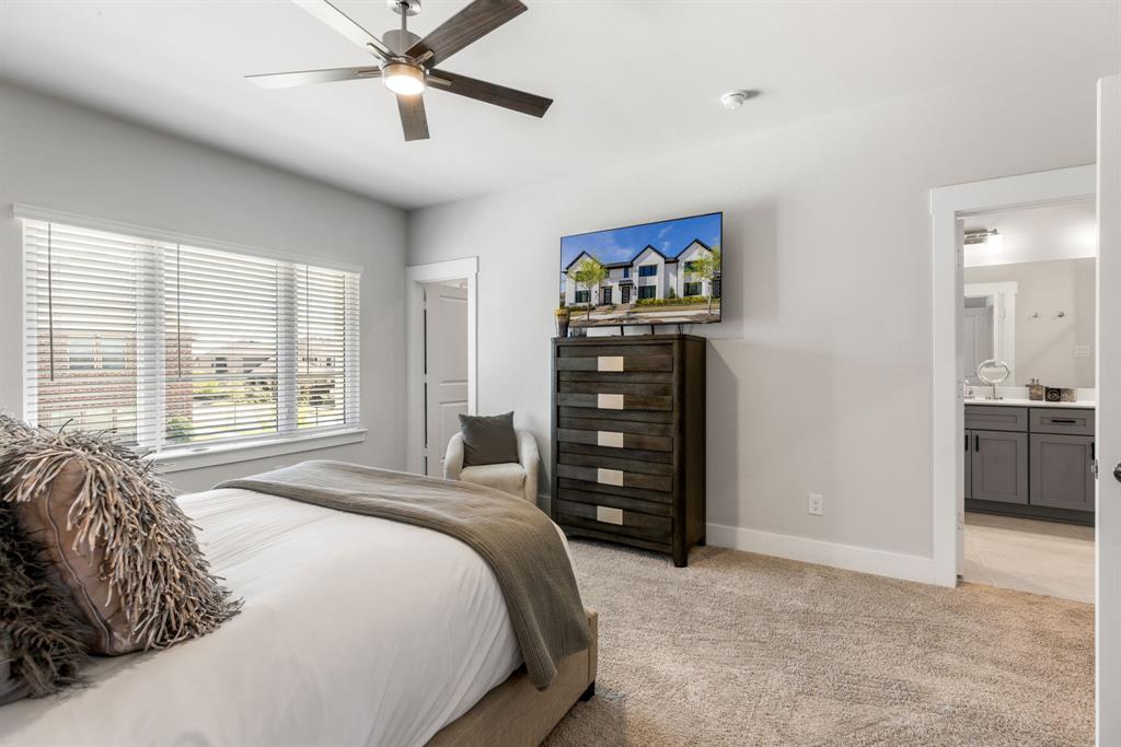 4502 Smokey Quartz Lane Arlington, TX 76005 - Photo 19 of 32 a bedroom with a bed and a chandelier