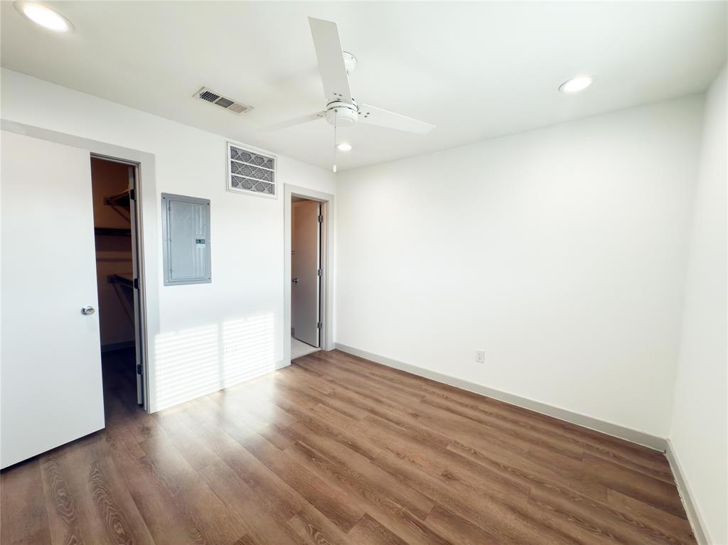 4526 Munger Avenue, Unit 208 Dallas, TX 75204 - Photo 11 of 19 an empty room with wooden floor and windows