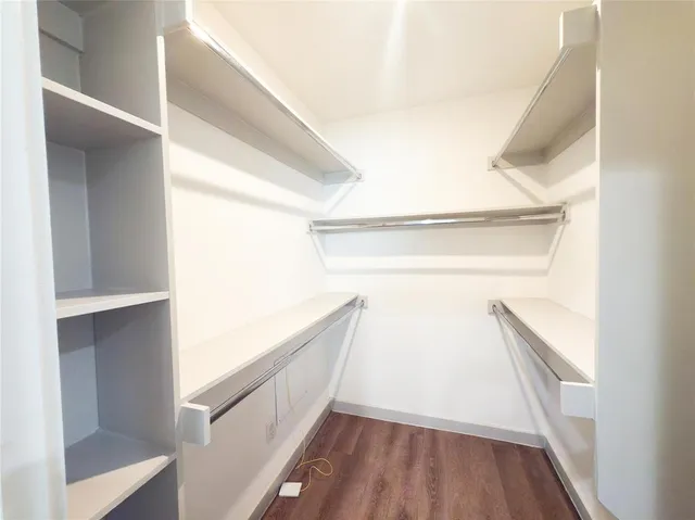 a view of closet with wooden floor
