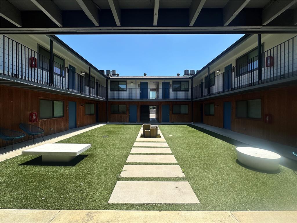 4526 Munger Avenue, Unit 208 Dallas, TX 75204 - Photo 18 of 19 a front view of a house with a yard