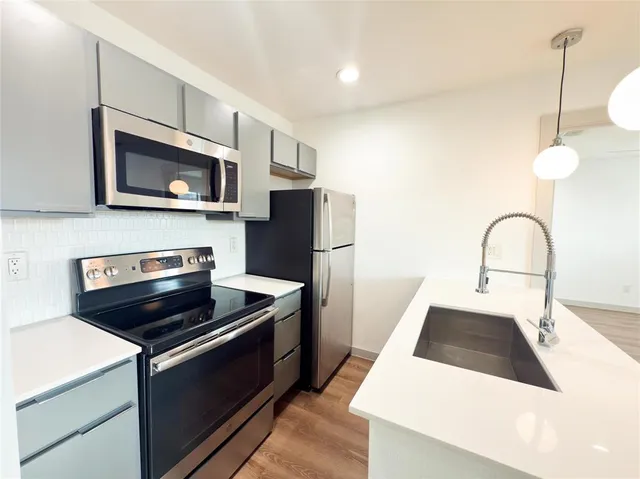 a kitchen with a refrigerator stove and microwave