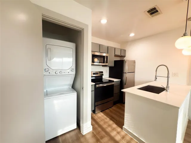 a kitchen with a refrigerator and a stove top oven