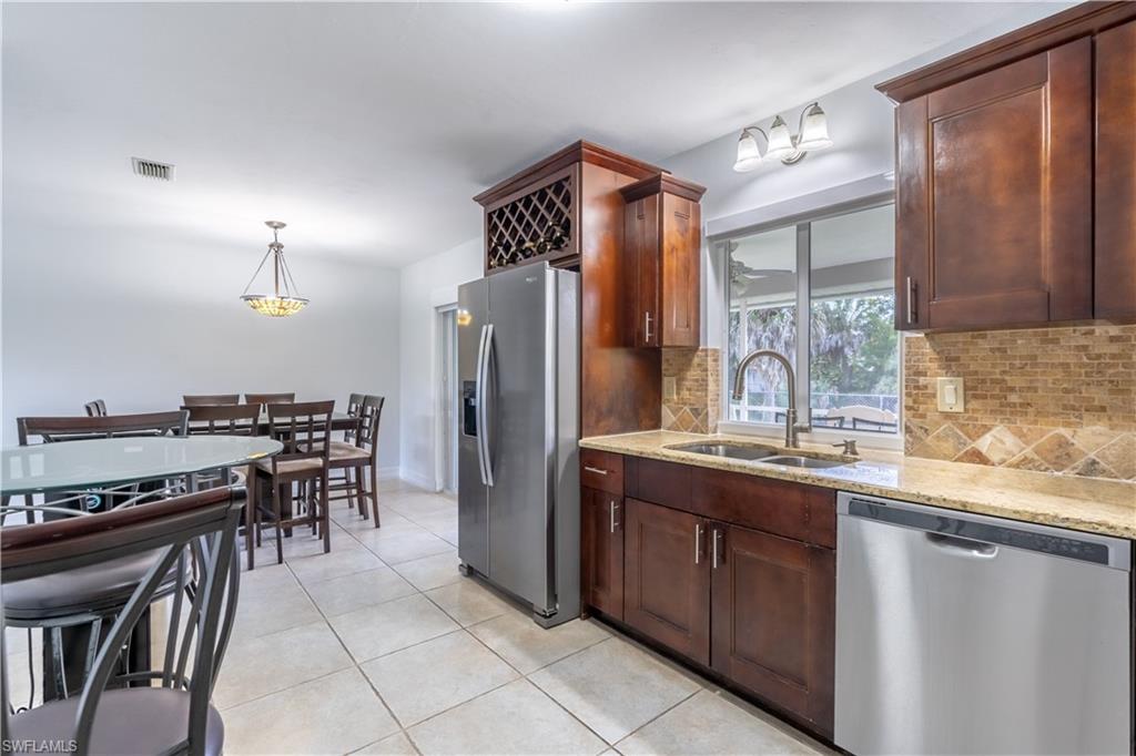 2100 55th Street Southwest Naples, FL 34116 - Photo 25 of 50 a kitchen with refrigerator and cabinets