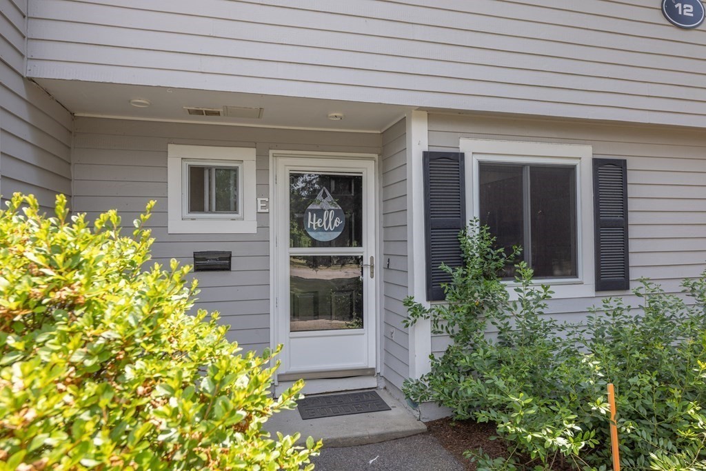 12 Beal's Cove Road, Unit E Hingham, MA 02043 - Photo 1 of 1 a front view of a house with a garage
